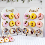 Two heart-shaped donut boards with variously decorated donuts on a white background.