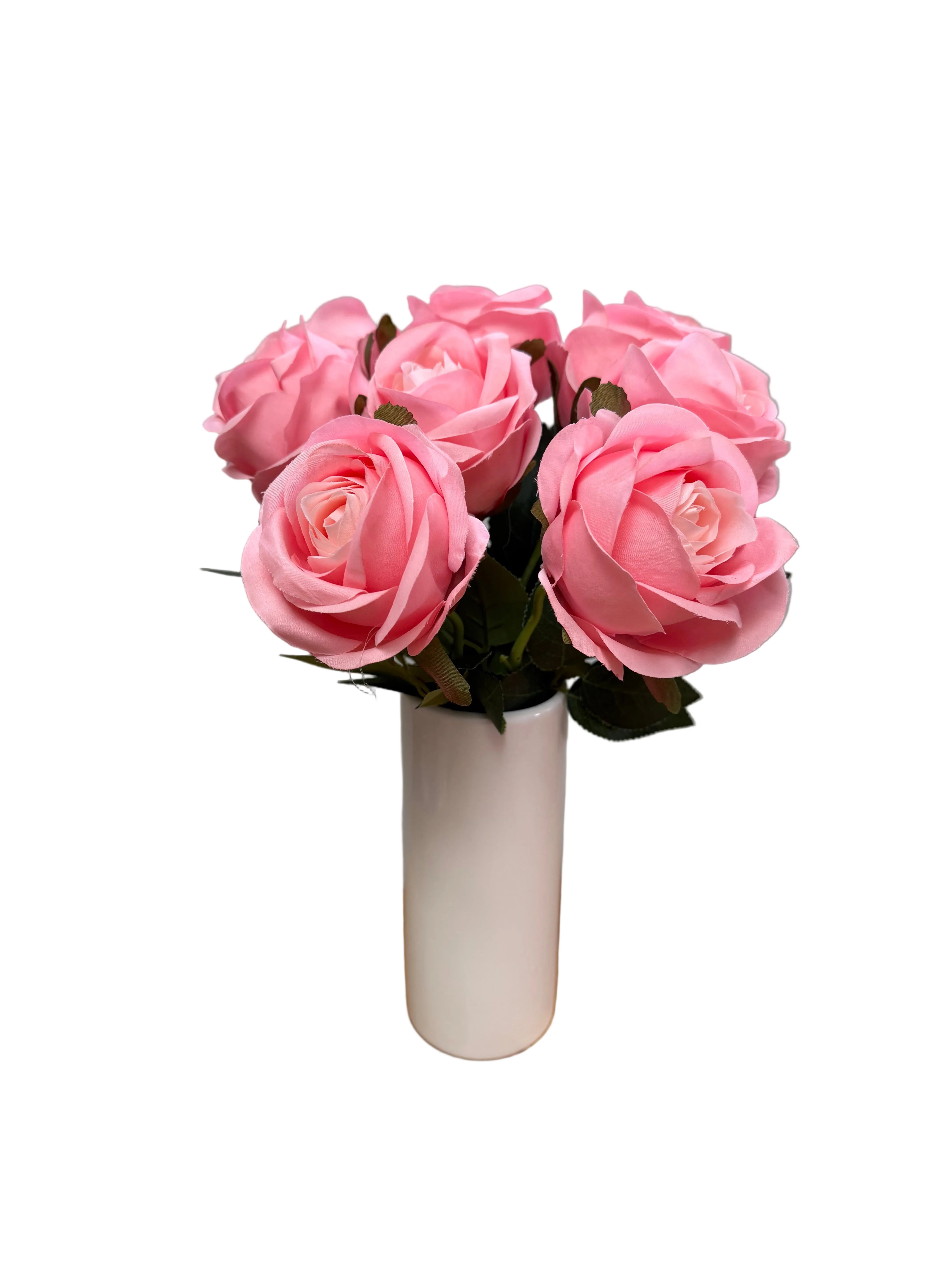 Bouquet of pink flowers on a wooden surface with a gray background