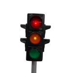 Traffic light showing red, yellow, and green lights on a white background
