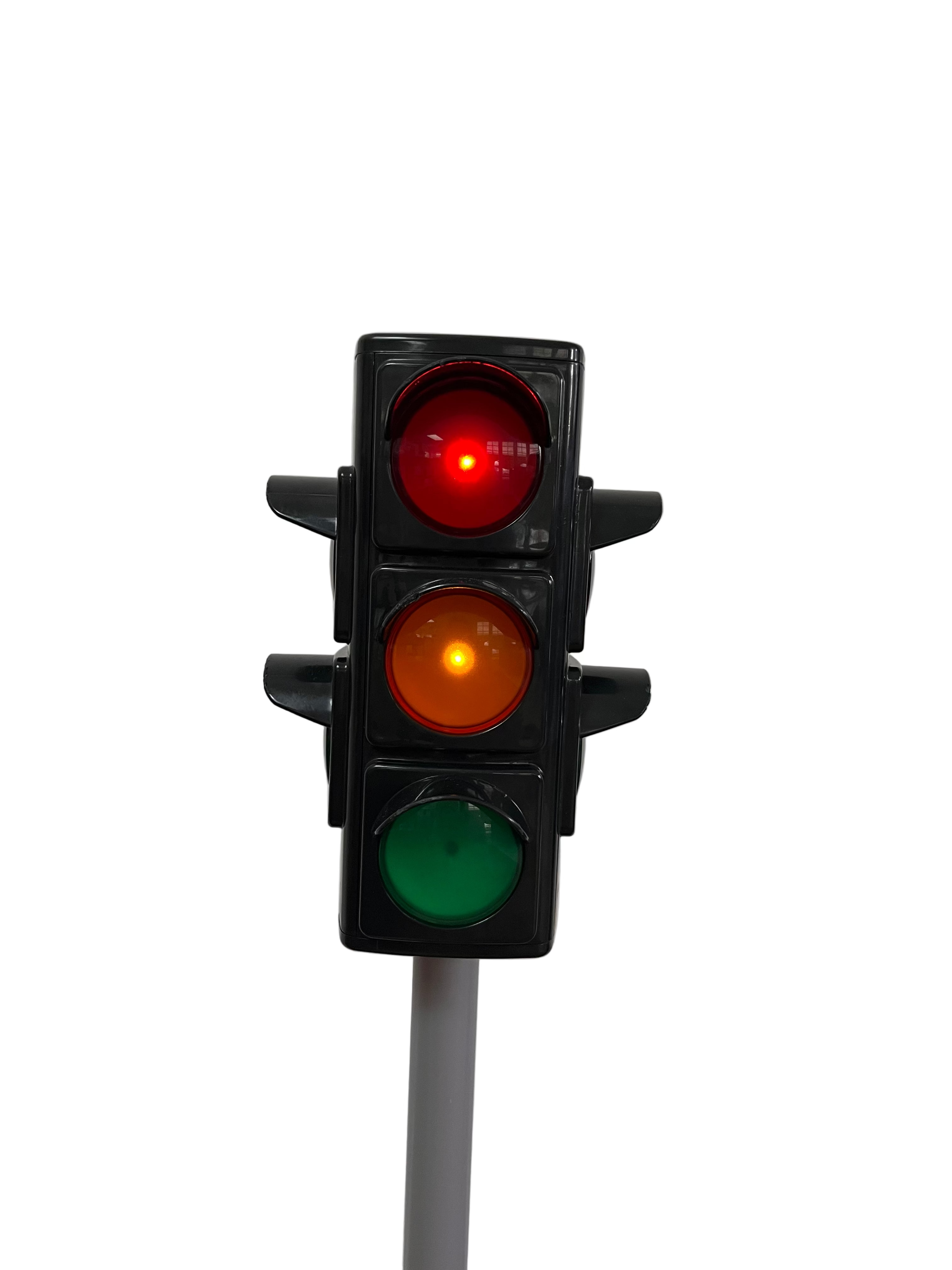 Traffic light showing red, yellow, and green lights on a white background