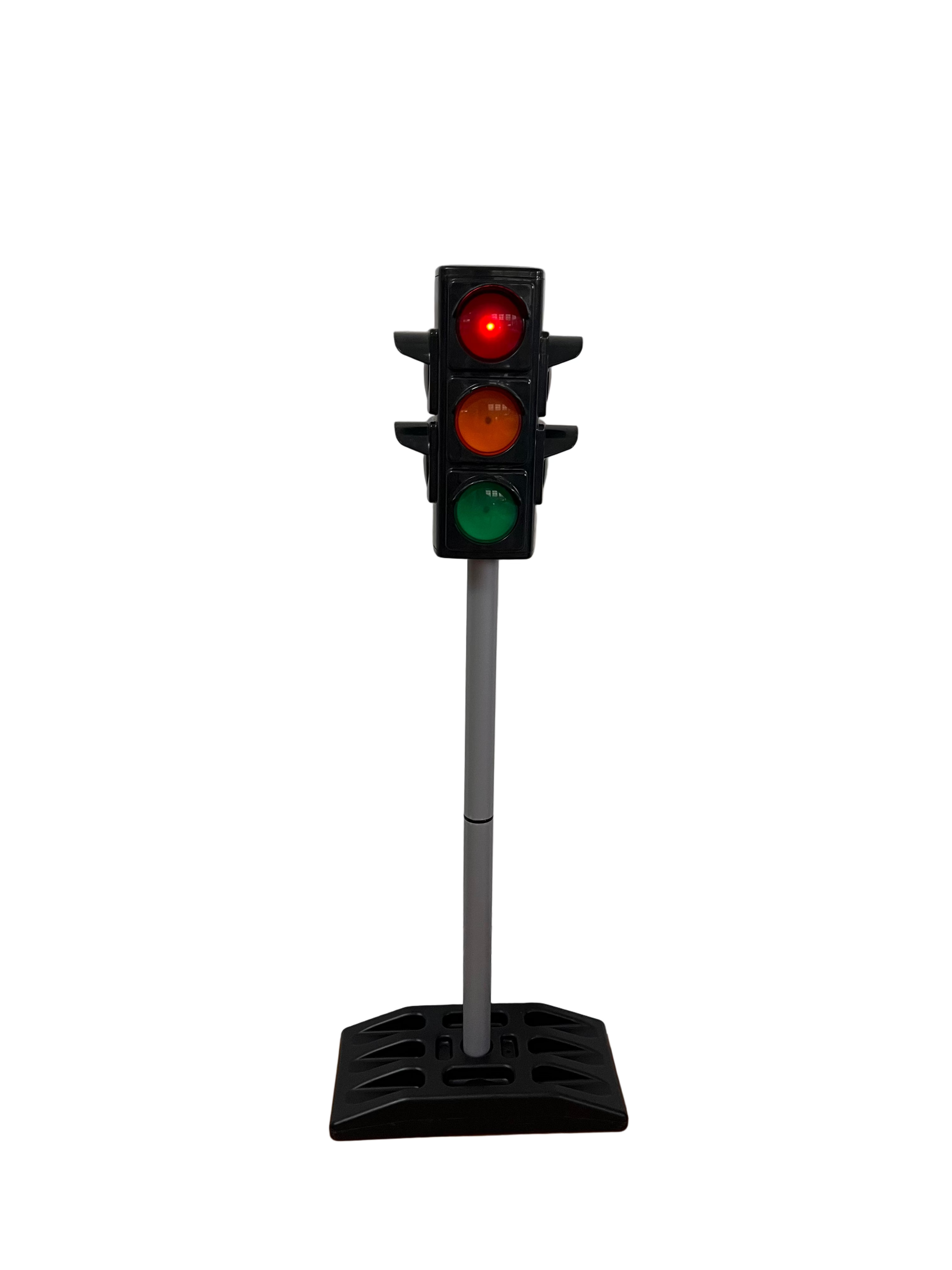 Miniature traffic light on a stand against a white wall.
