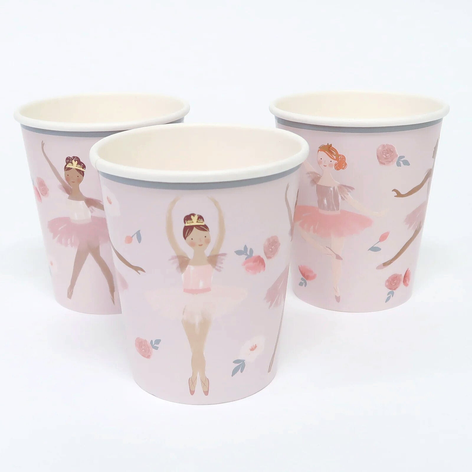 Three paper cups with ballerina design on a white background