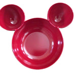 Red bowl shaped like a face with two round ears on a white background