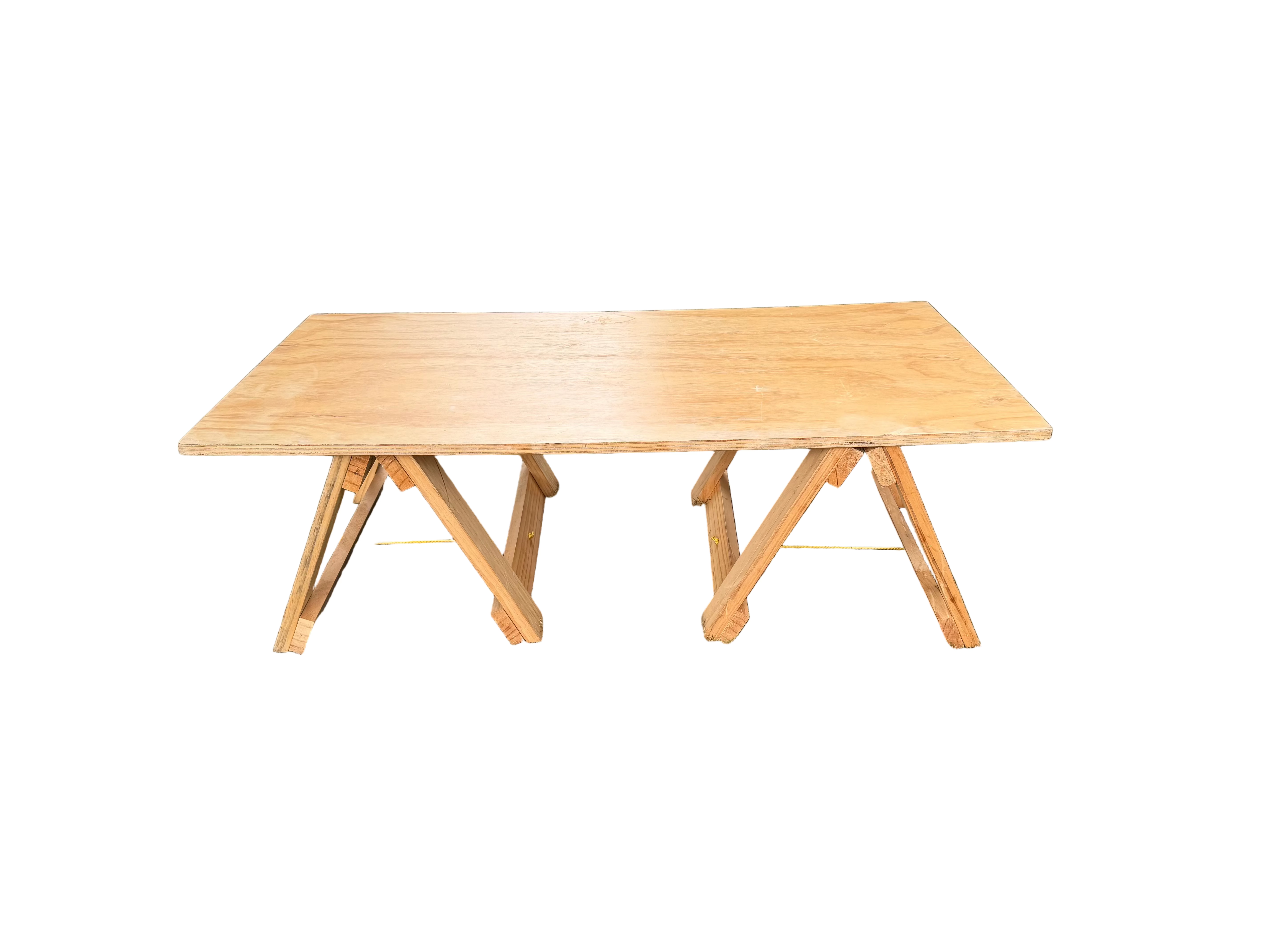 Wooden table on a grassy area with a garden and house in the background