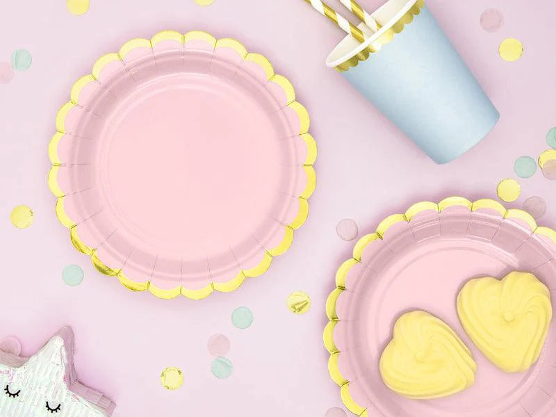 Pink and yellow children's plates with heart designs on a pink background