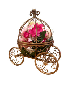 Decorative metal holder with pink flowers on a wooden surface