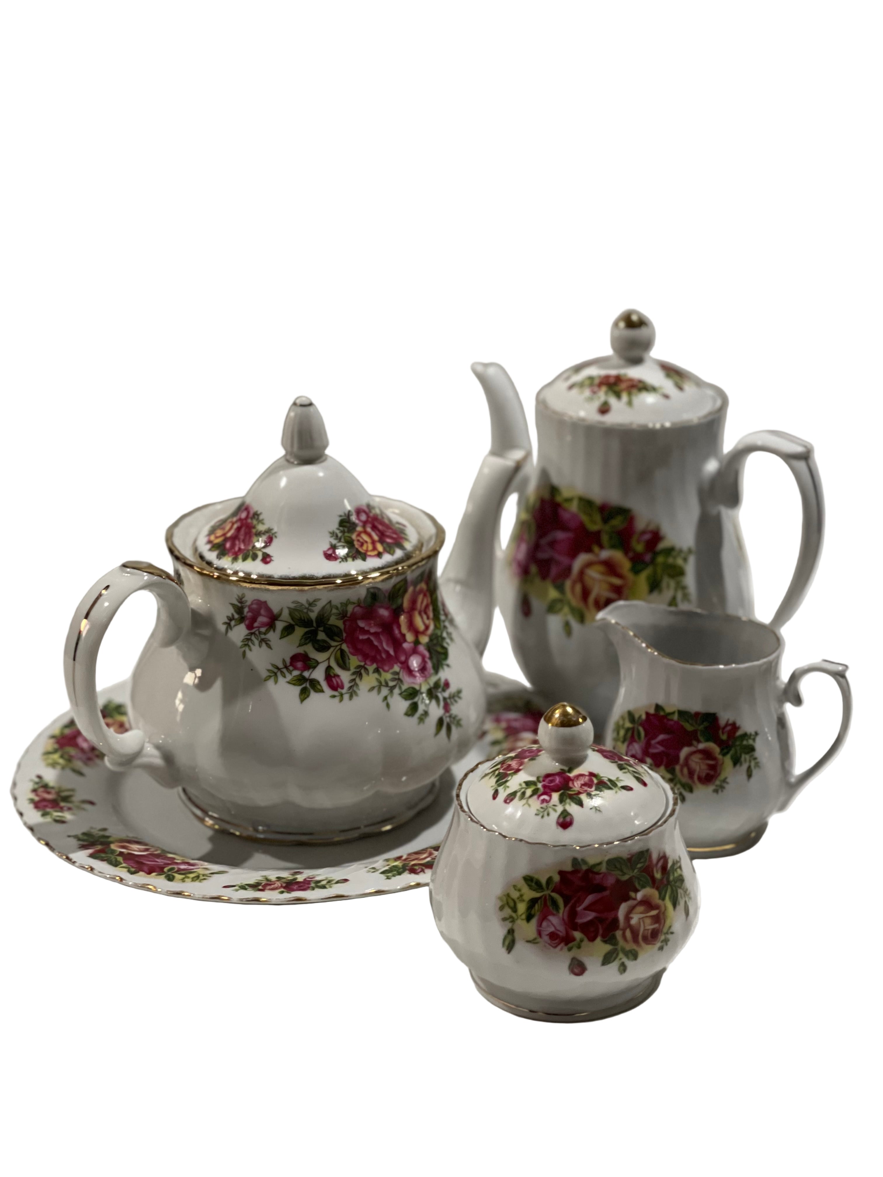 Ceramic tea set with floral patterns on a white background