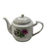 White teapot with floral design on a white background