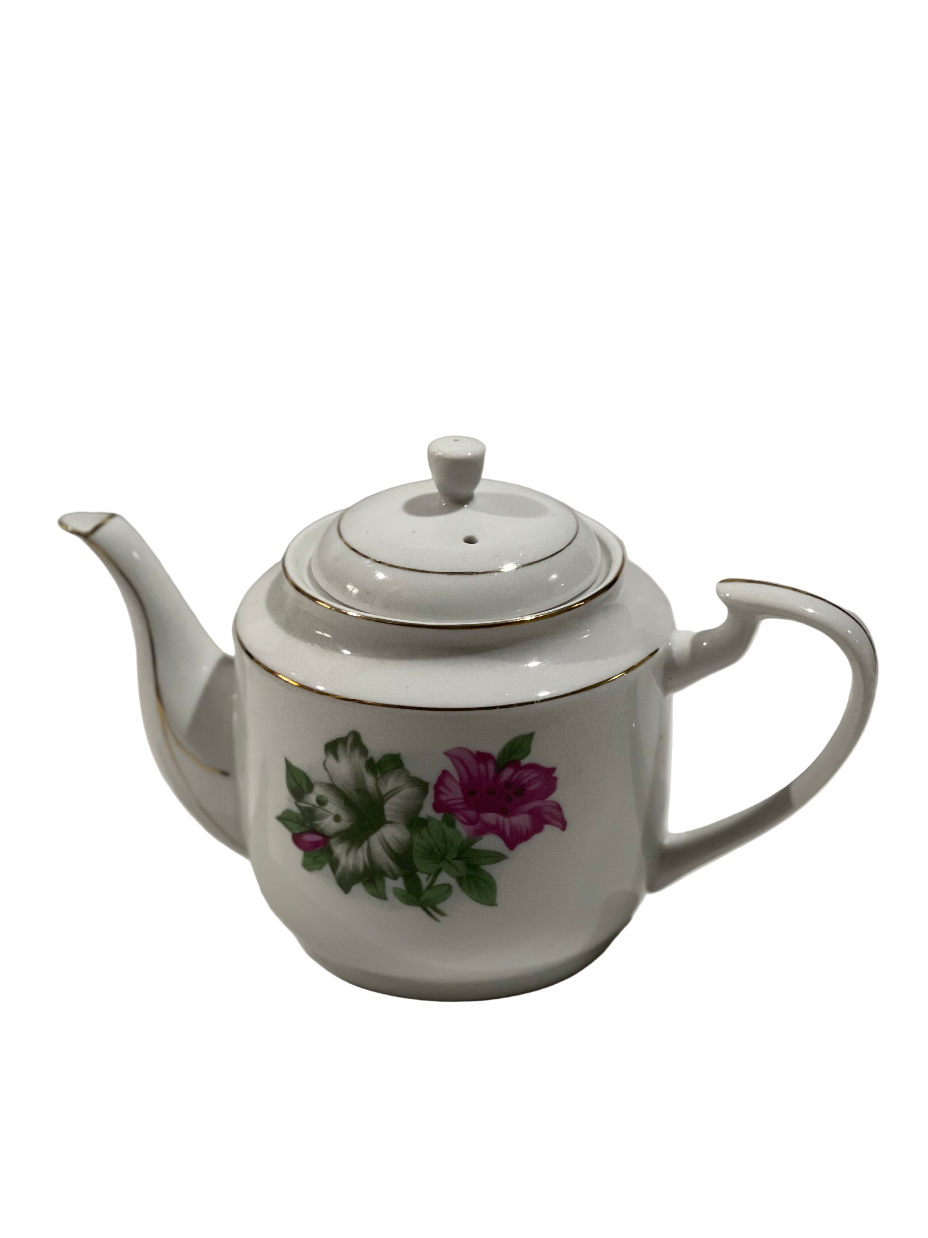 White teapot with floral design on a white background
