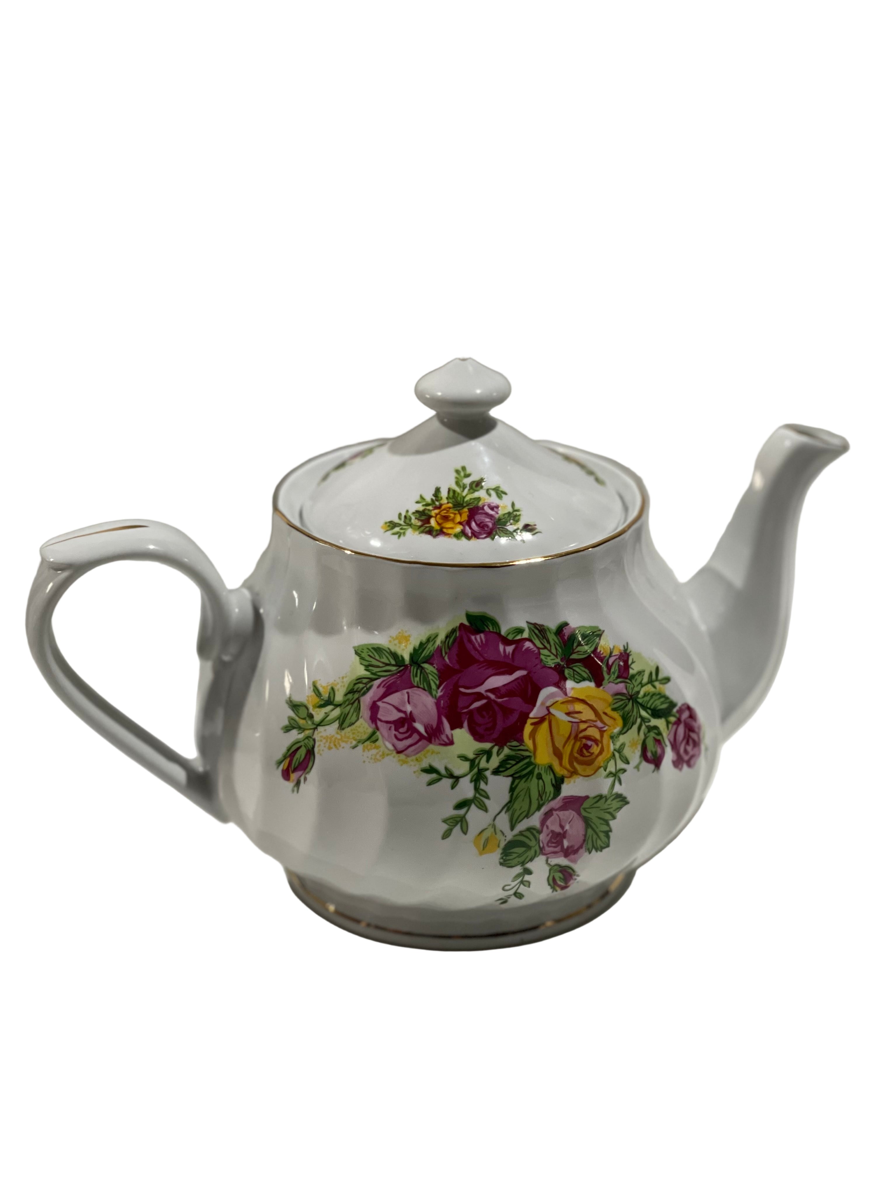 White teapot with floral design on a white background