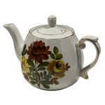 Teapot with floral design on a white background