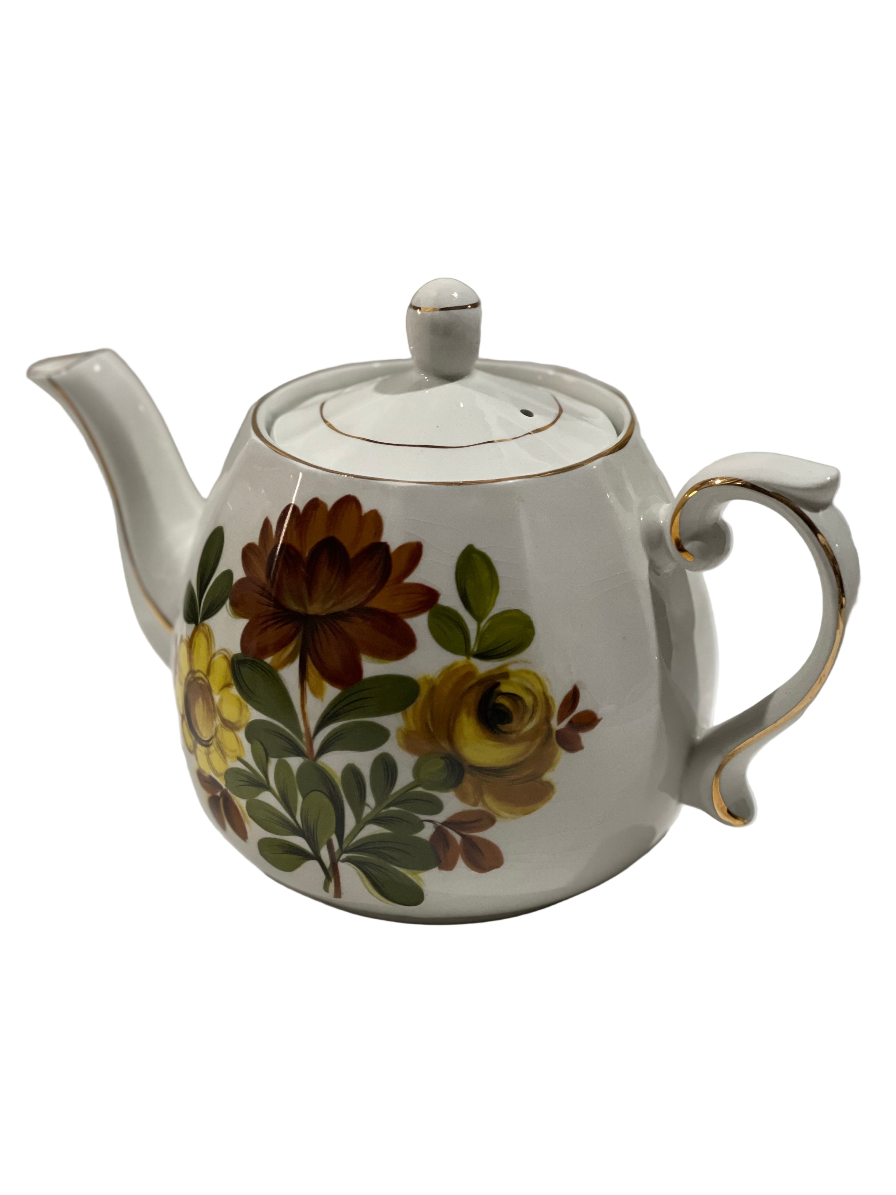 Teapot with floral design on a white background