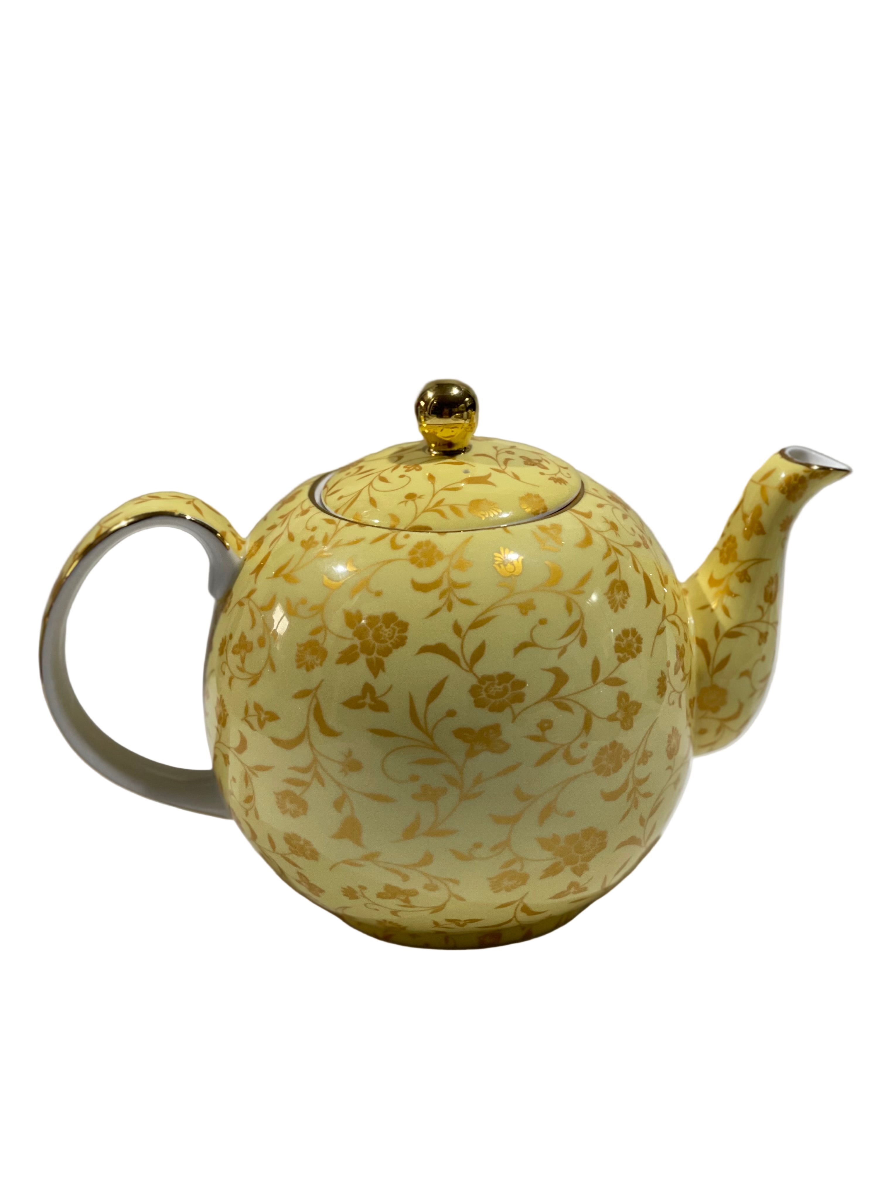 Yellow teapot with floral patterns on a white background